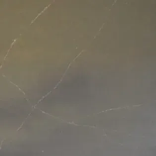 A close up of a gray surface with a few lines on it.