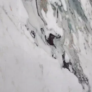 A close up of a white marble counter top with a marble texture.