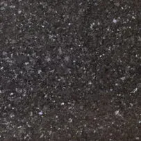 A close up of a black granite counter top with white spots.