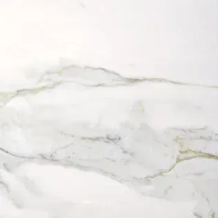 A close up of a white marble counter top.
