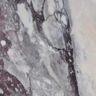 A close up of a marble surface with a purple and white marble texture.