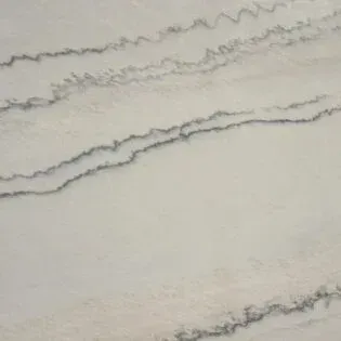 A close up of a white marble counter top with black lines.