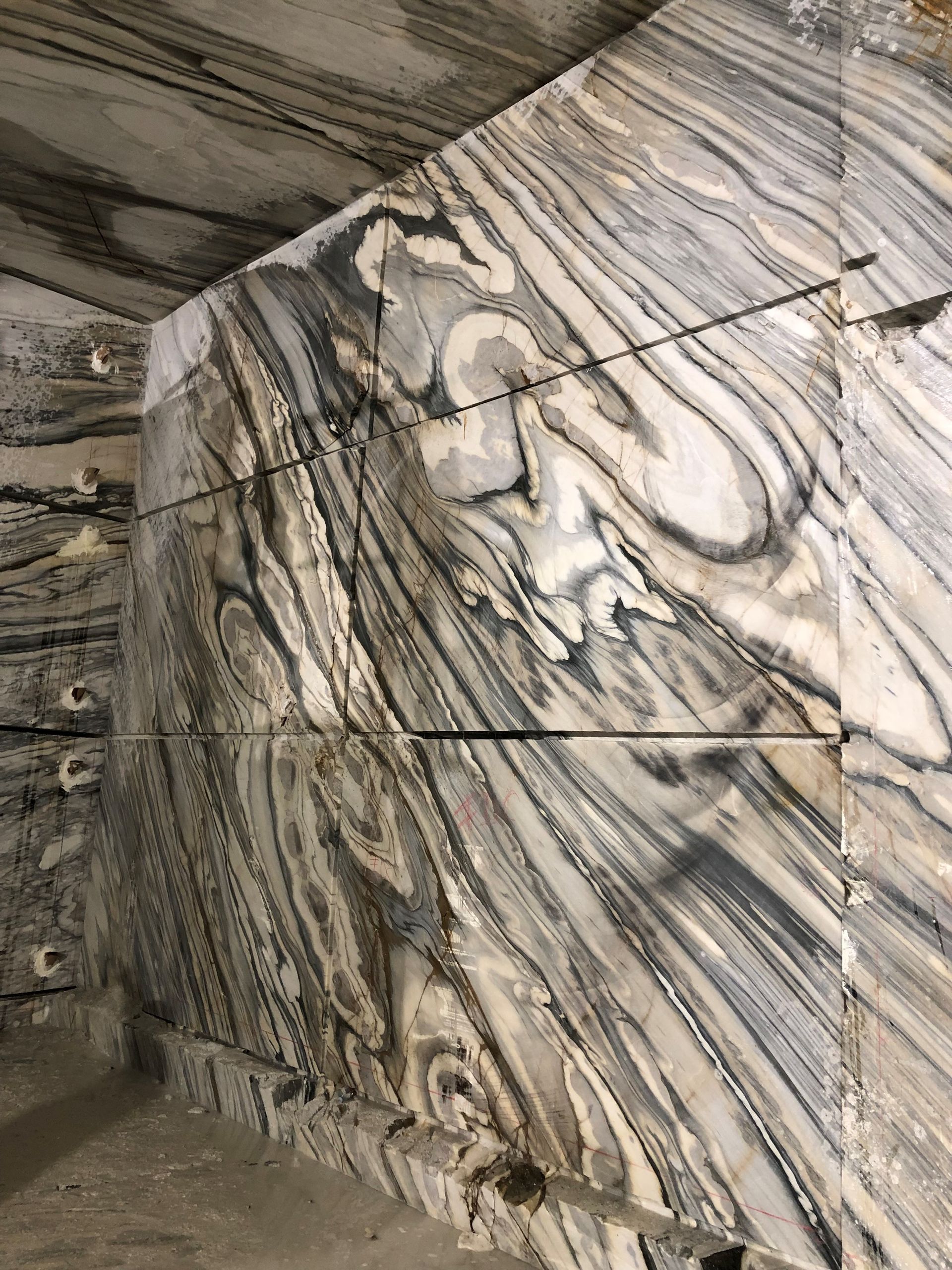 A close up of a marble floor with a swirl pattern.