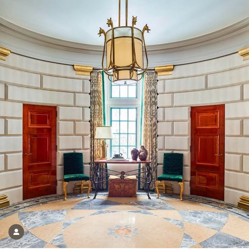 A round room with a chandelier hanging from the ceiling