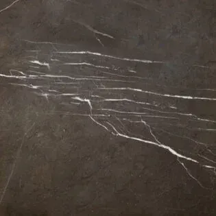 A close up of a black marble counter top with white veins.