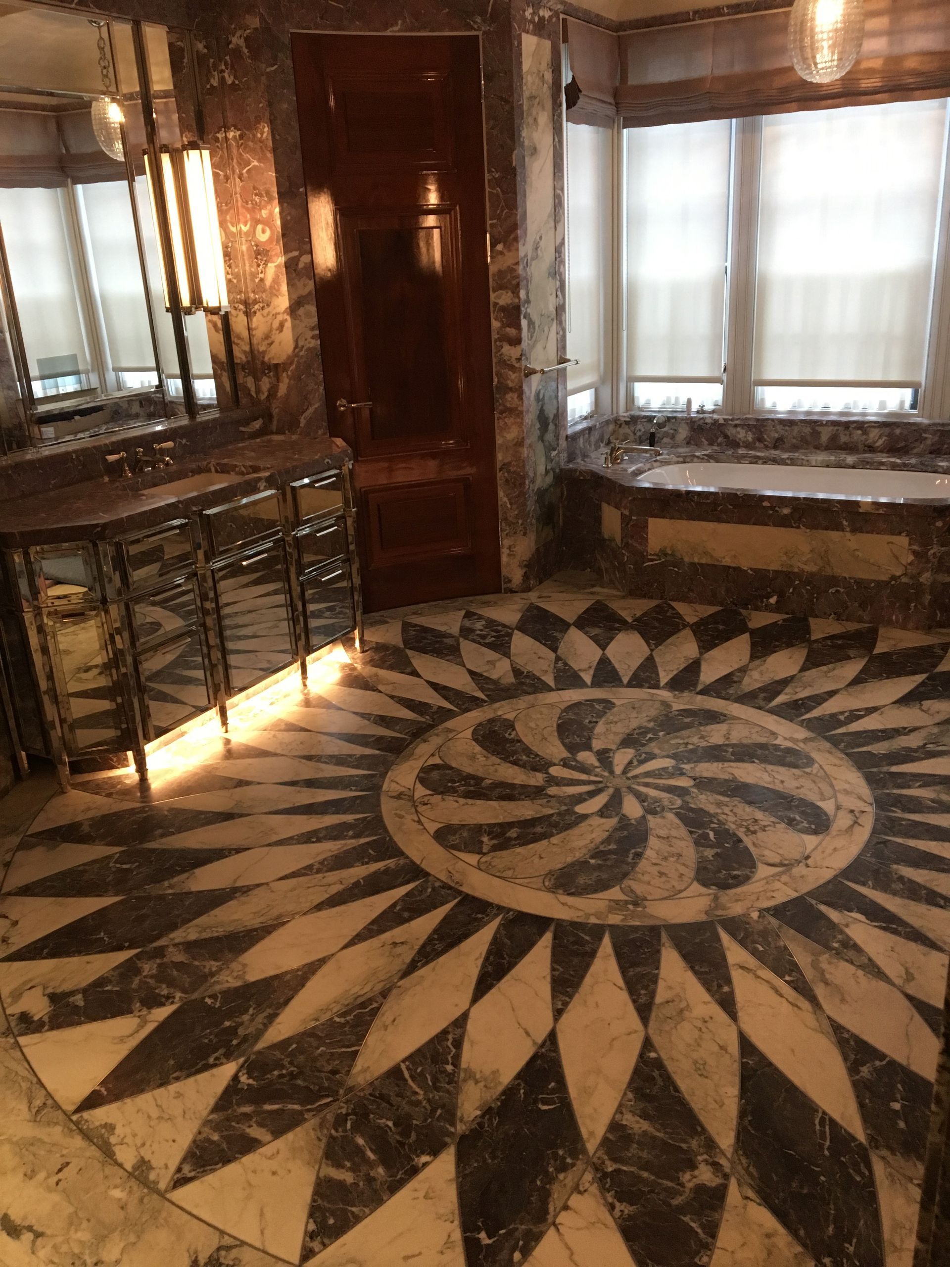 A bathroom with a circular pattern on the floor