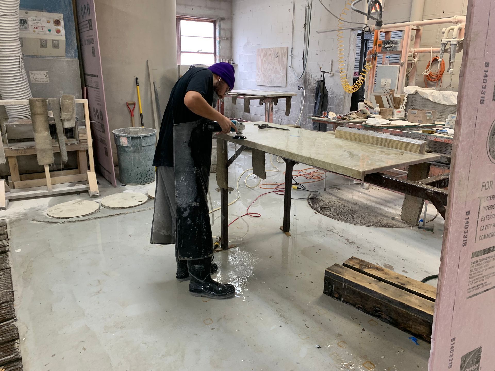 A man is working on a table in a workshop.