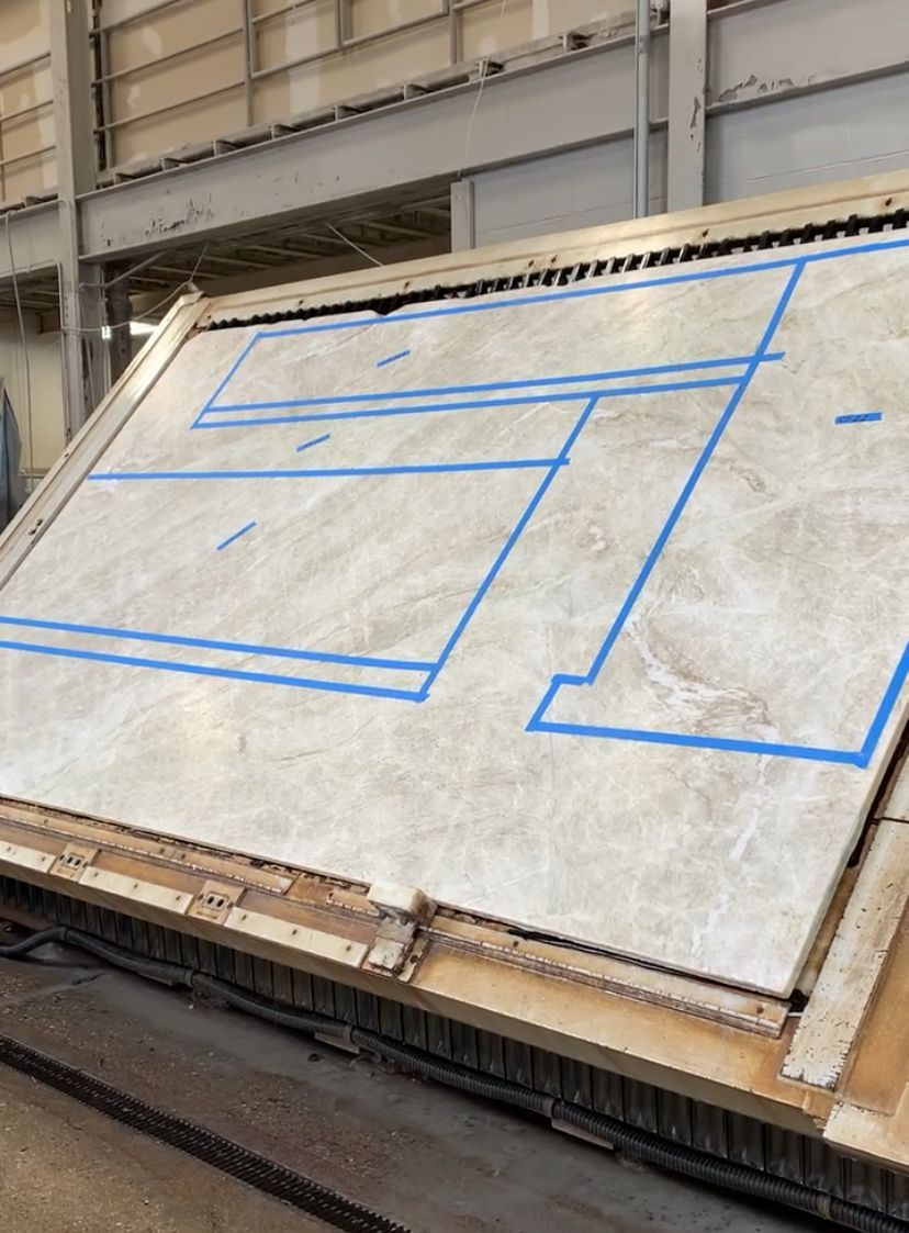 A large piece of concrete with blue tape on it.