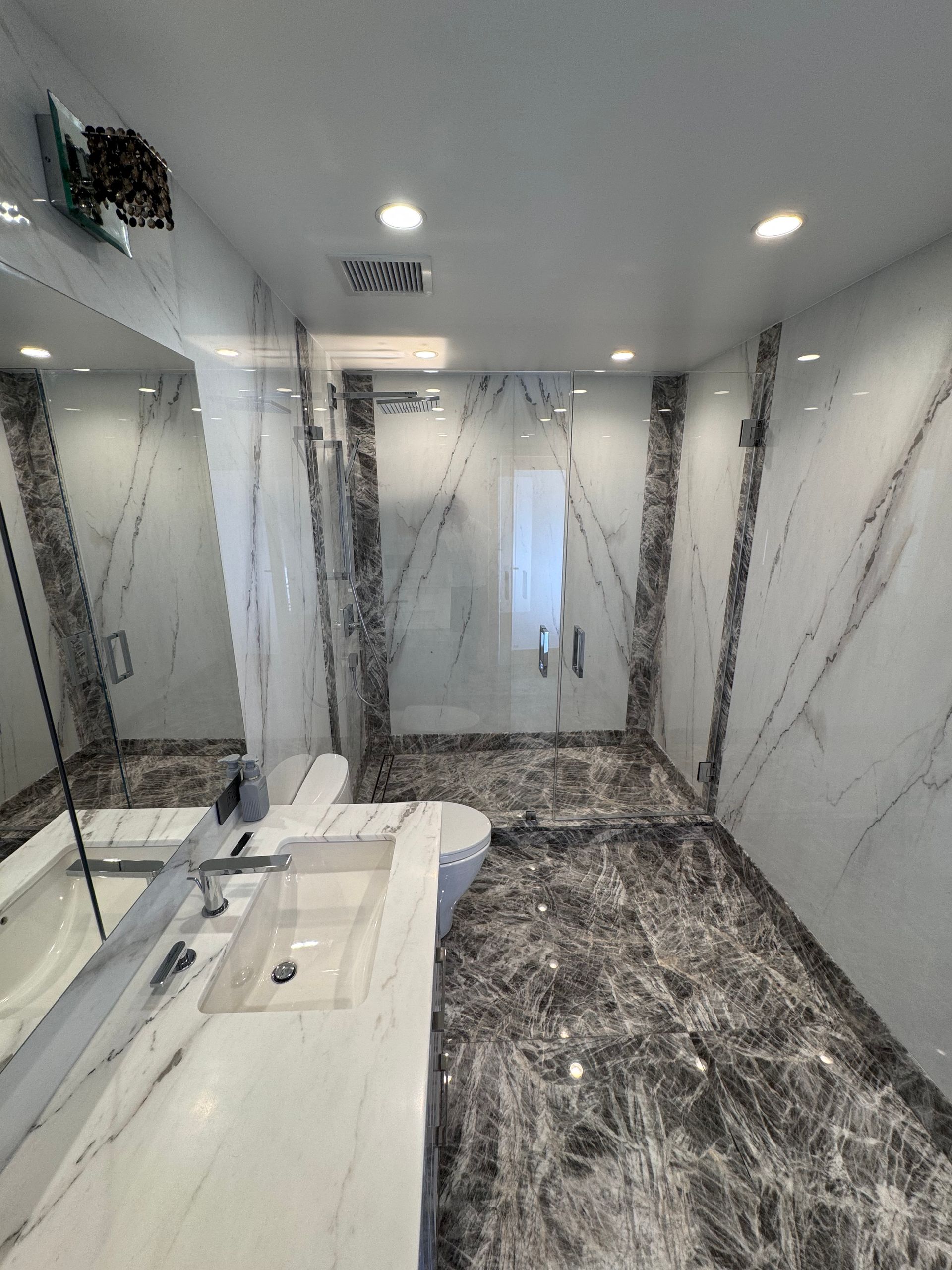 A bathroom with a bathtub , sink , shower and mirror.