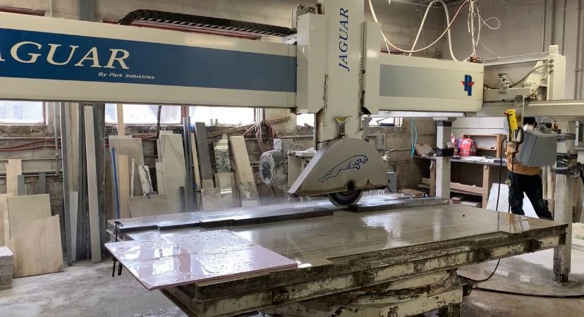 A man is working on a machine in a factory.