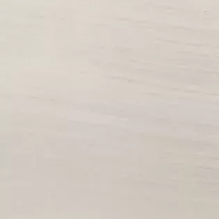 A close up of a white tile with a grainy texture.