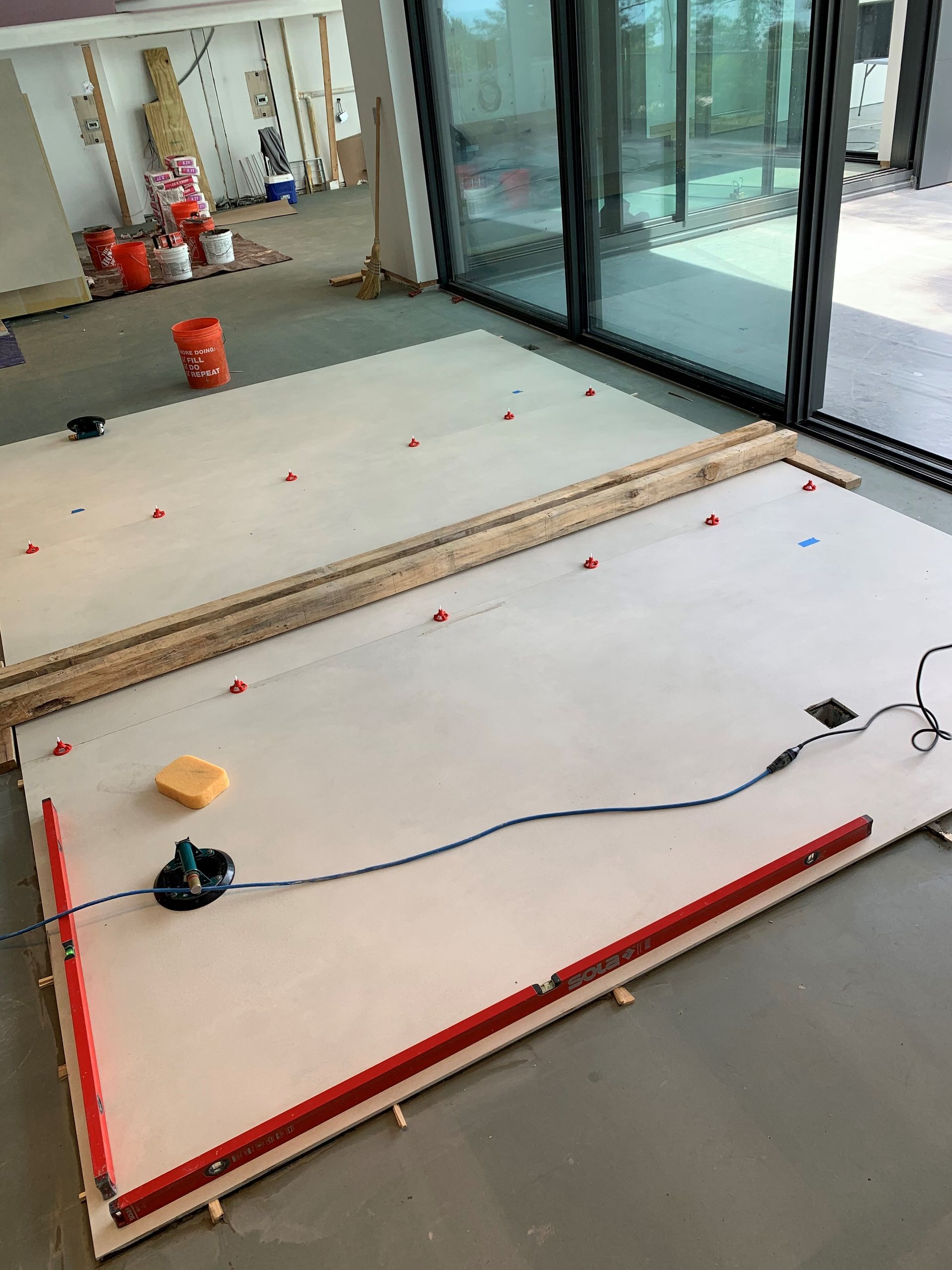 A large piece of wood is laying on the floor in a room.