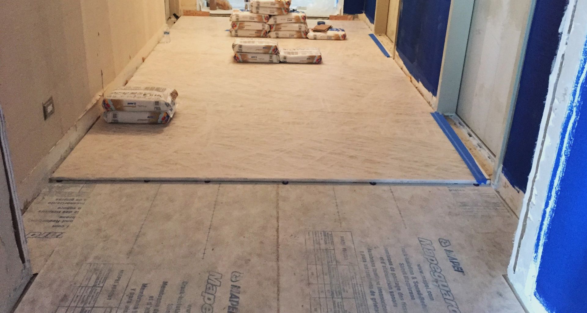 A hallway with a lot of tiles on the floor