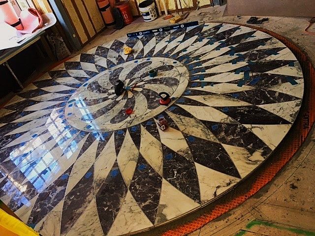 A circular marble floor with a checkered pattern