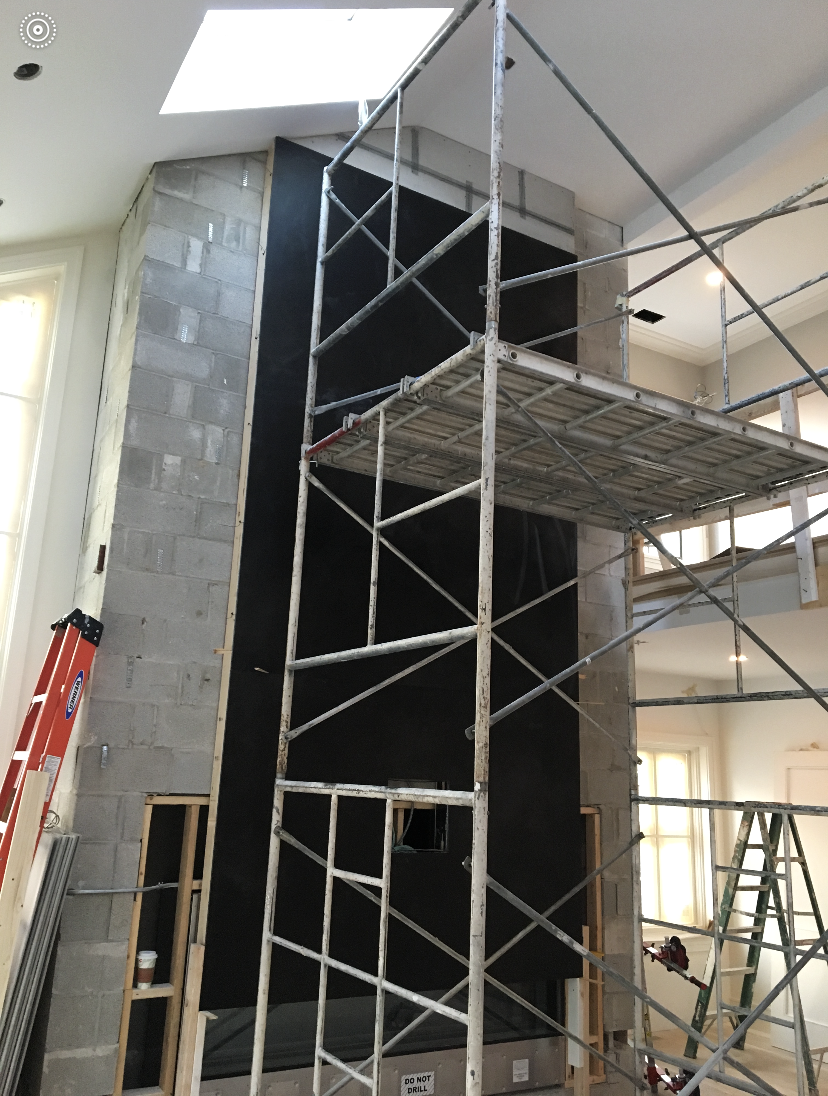 A scaffolding in a room with a ladder in the background