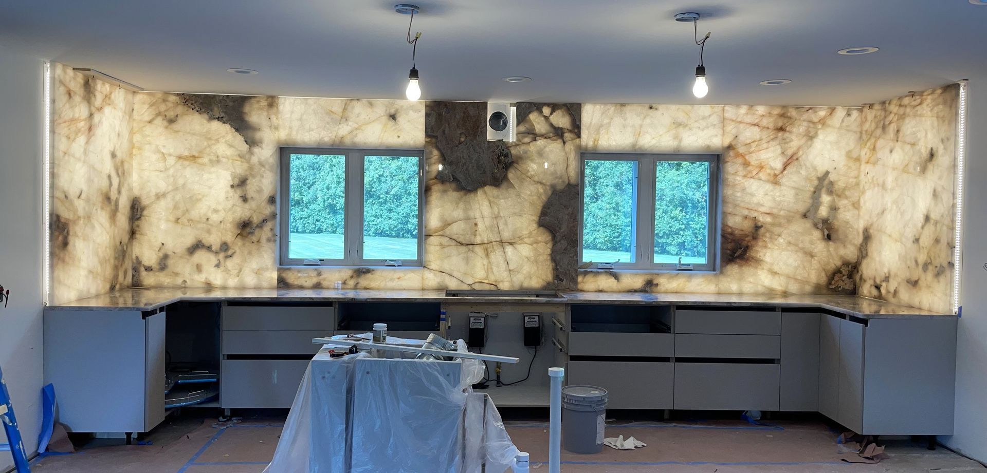 A kitchen is being remodeled with a marble counter top