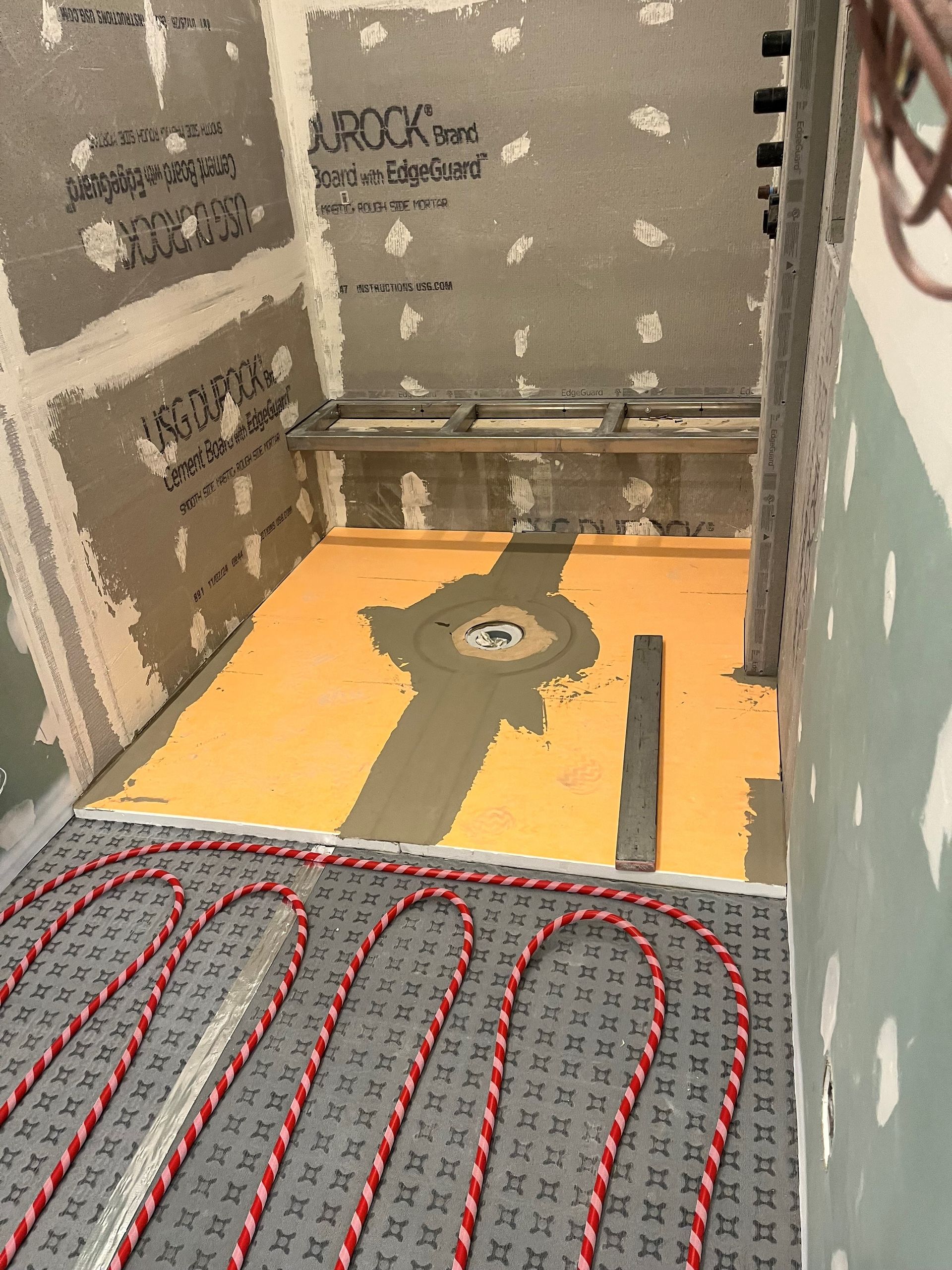 A bathroom under construction with a yellow floor