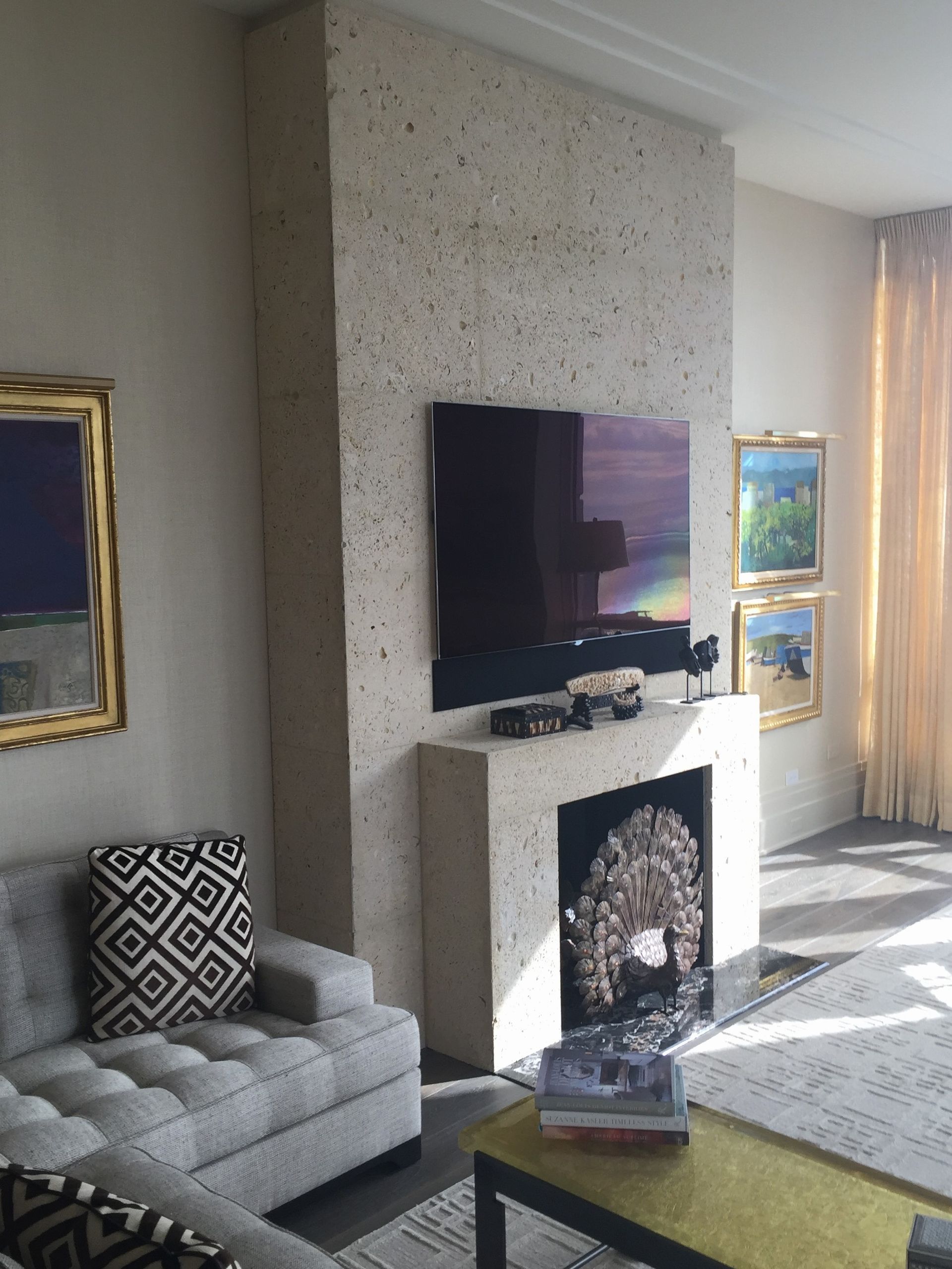 A living room with a fireplace and a flat screen tv