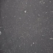 A close up of a black surface with white dots on it.