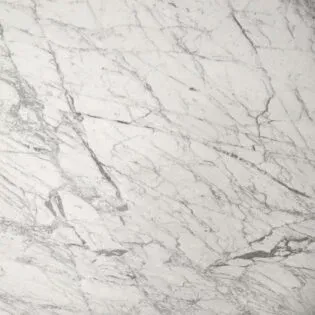 A close up of a white marble counter top.