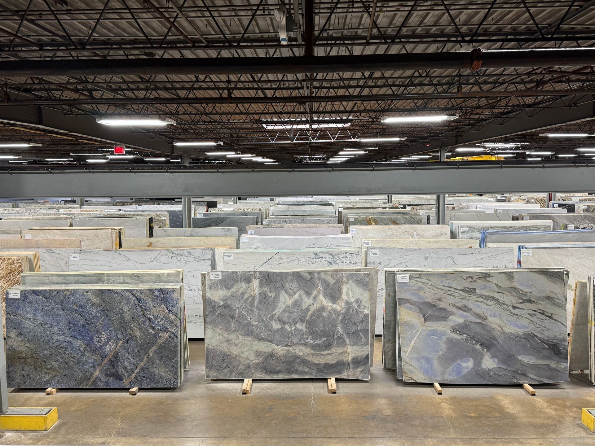 A large warehouse filled with lots of marble slabs.