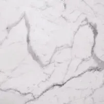 A close up of a white marble counter top.