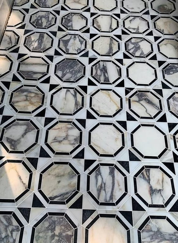 A black and white marble floor with a geometric pattern.