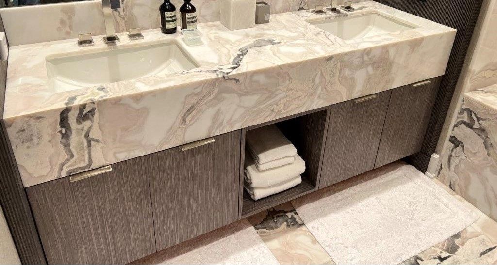 A bathroom with two sinks and a towel rack.