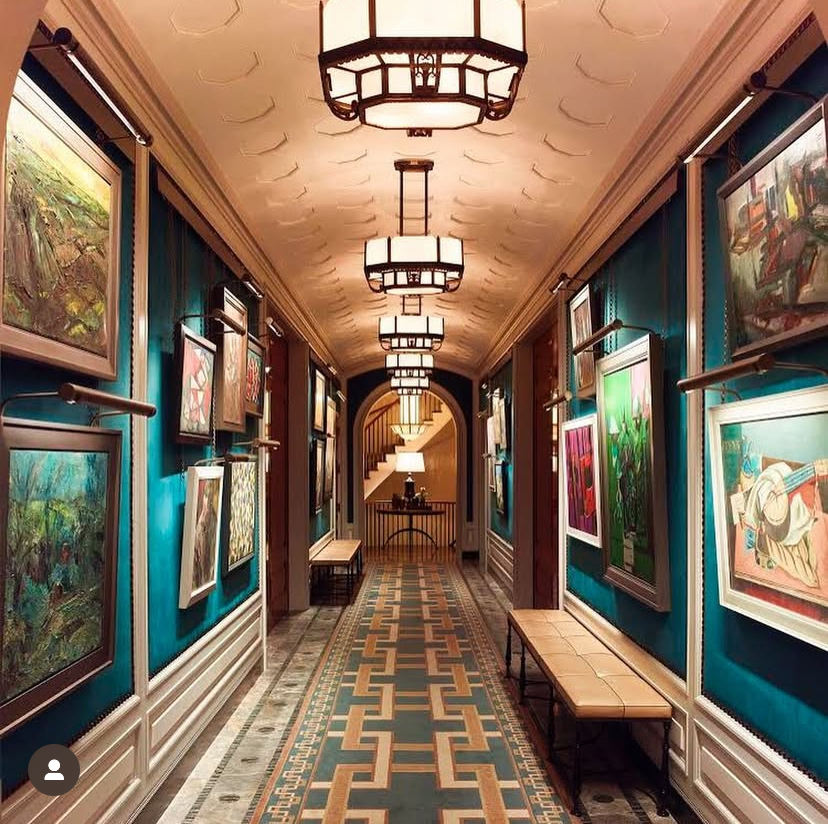 A hallway with lots of paintings on the walls