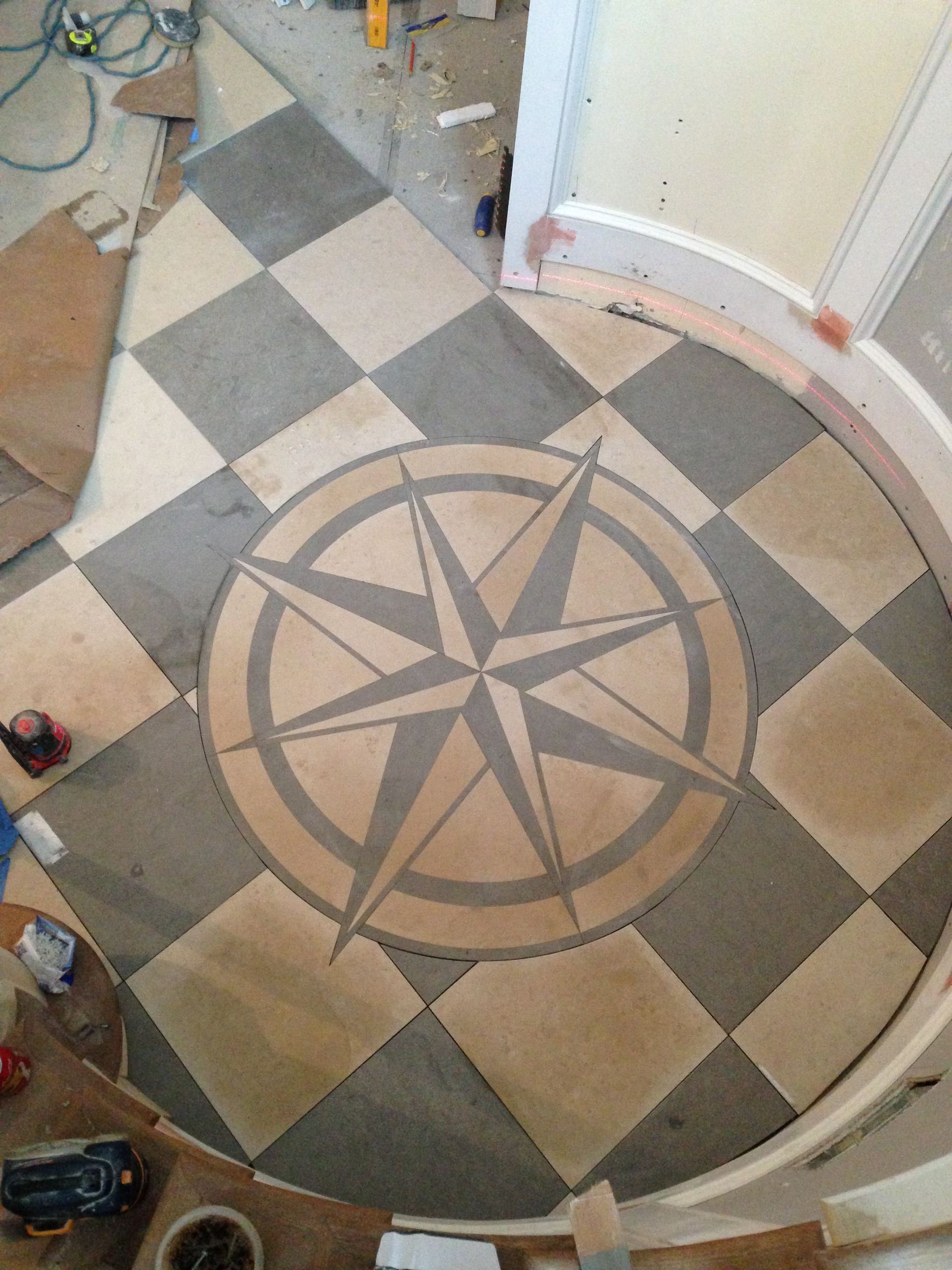 A checkered floor with a compass in the middle