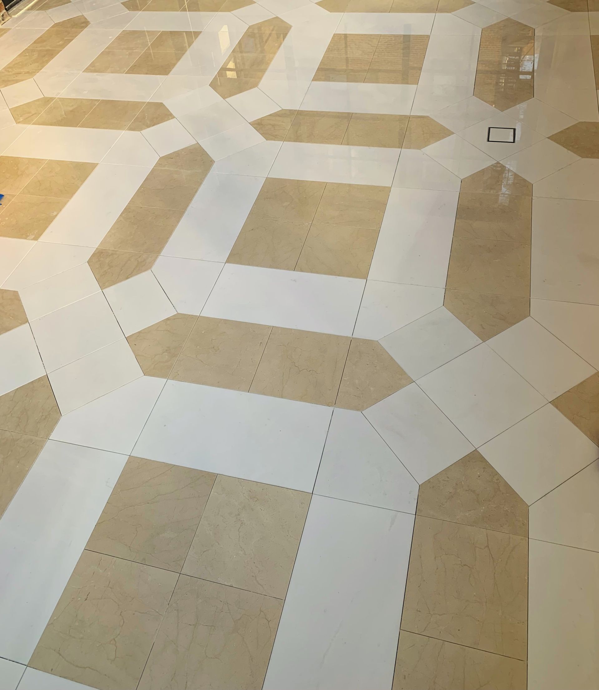 A marble floor with a pattern of squares and lines