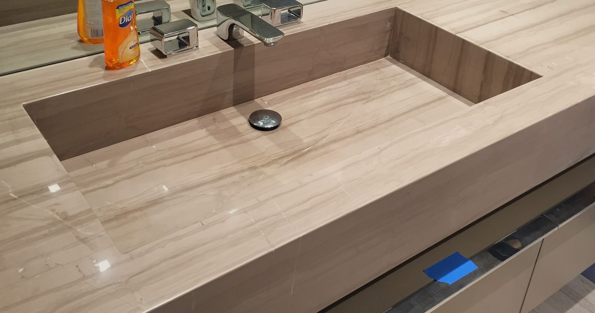 A bathroom sink with a faucet and a mirror.