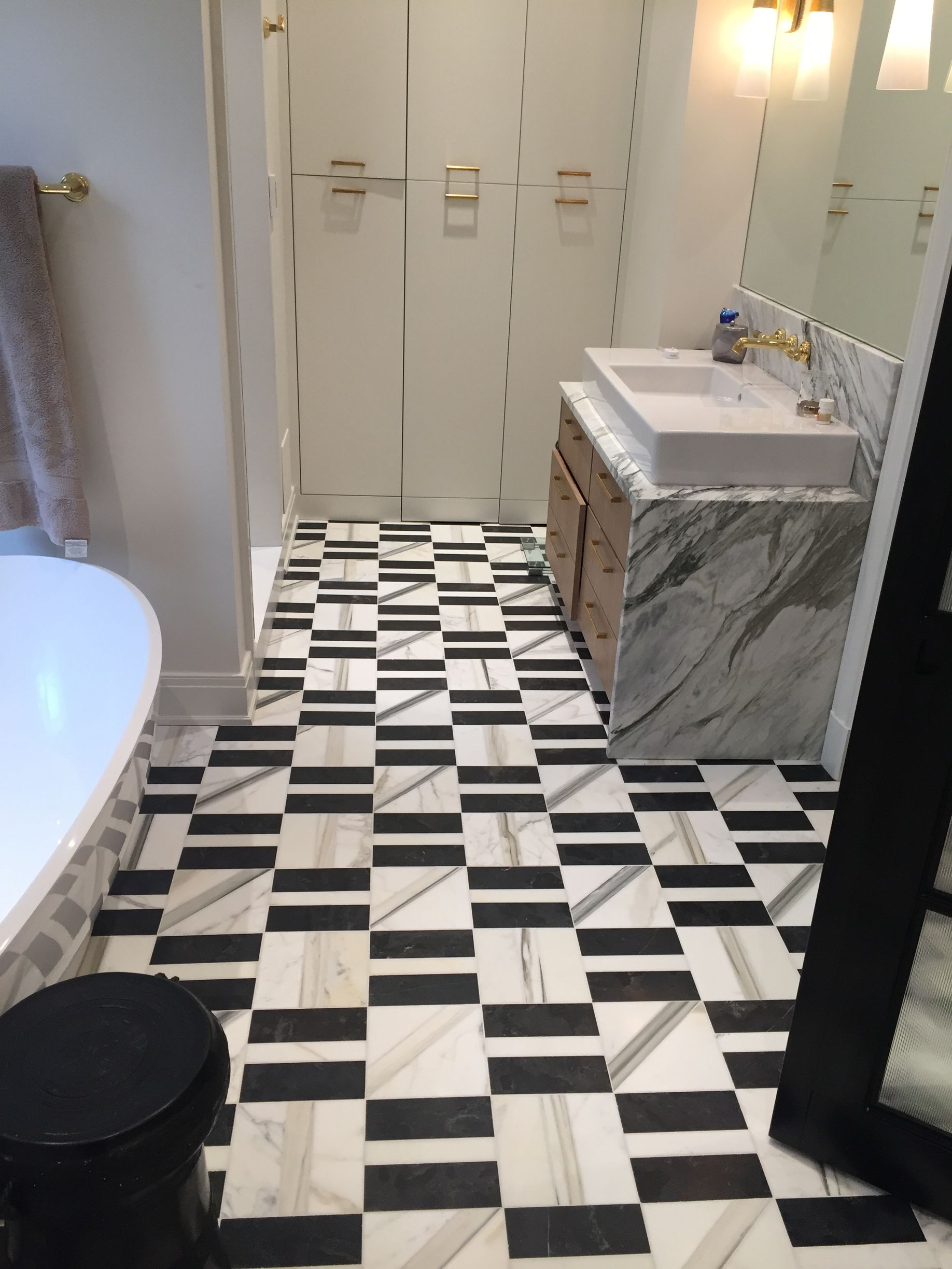 A bathroom with a black and white checkered floor
