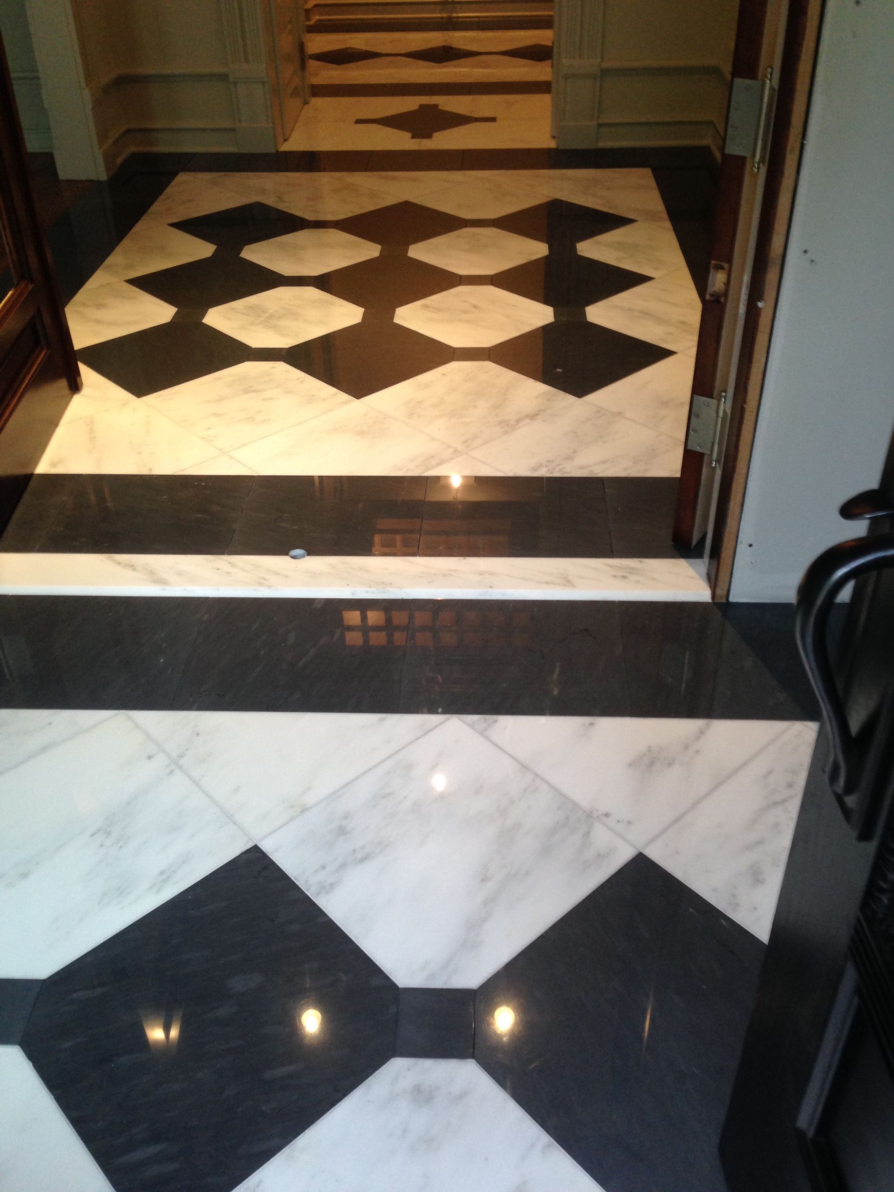A black and white checkered floor in a hallway