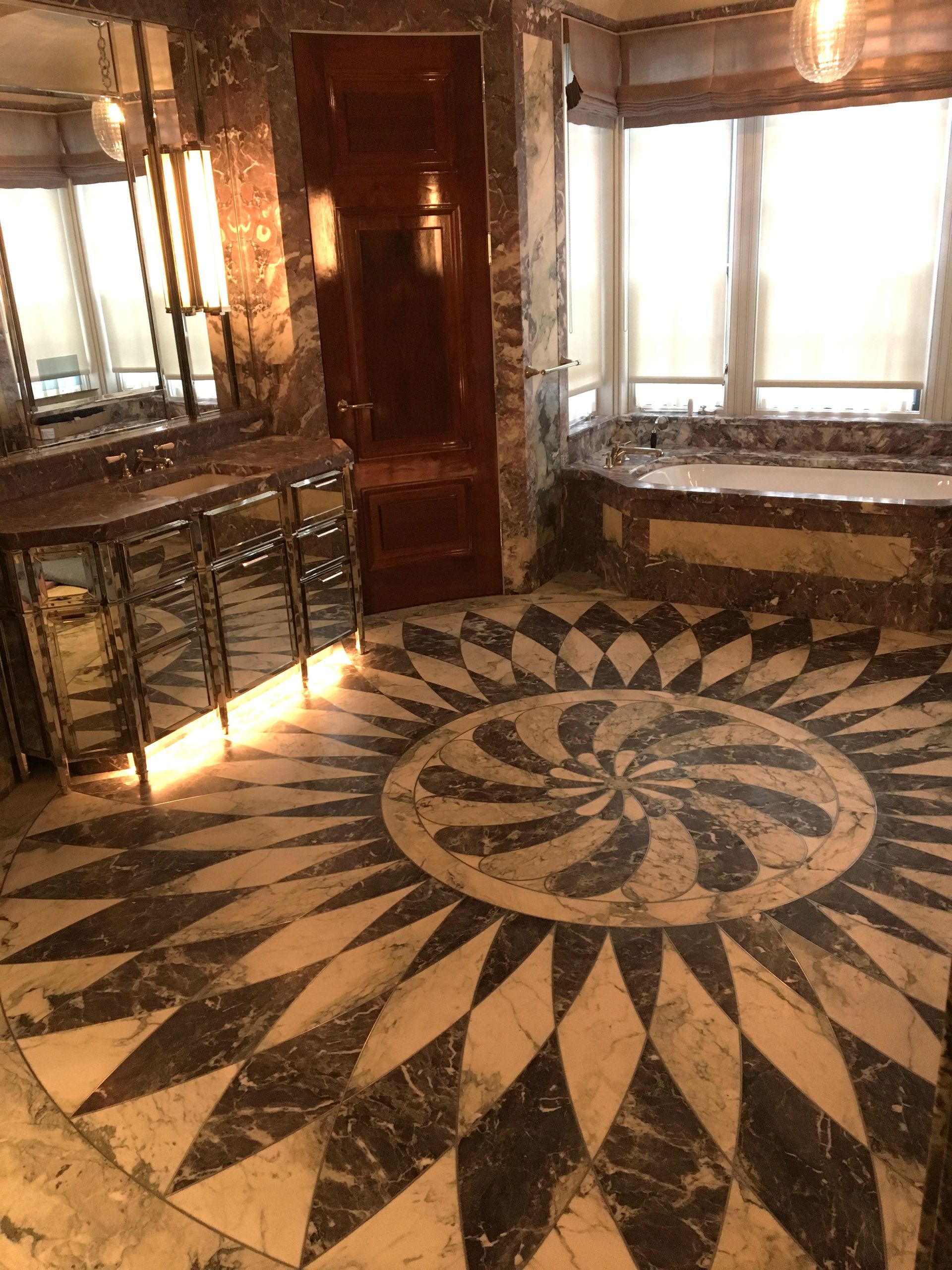 A bathroom with a circular pattern on the floor