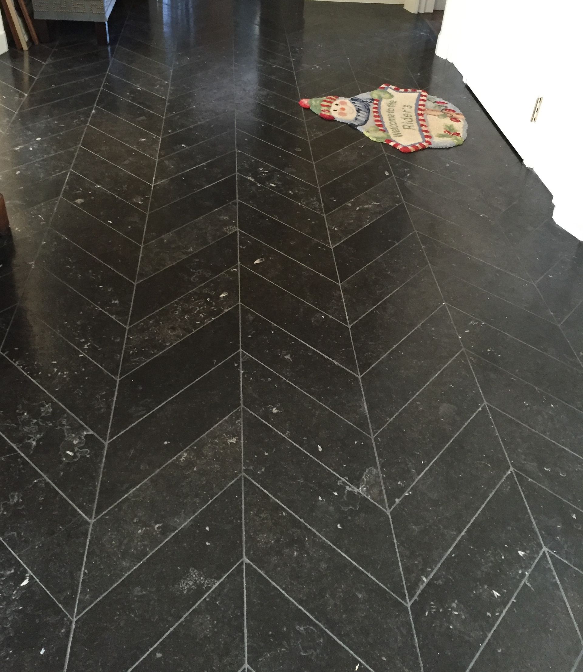 A black tile floor with a chevron pattern