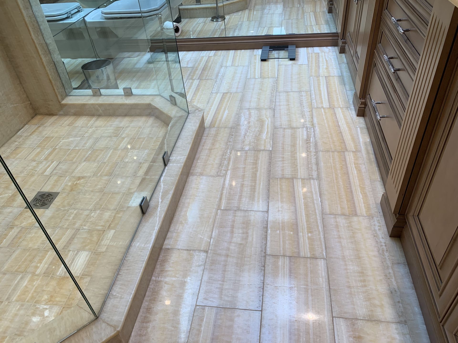 A bathroom with a walk in shower and a mirror