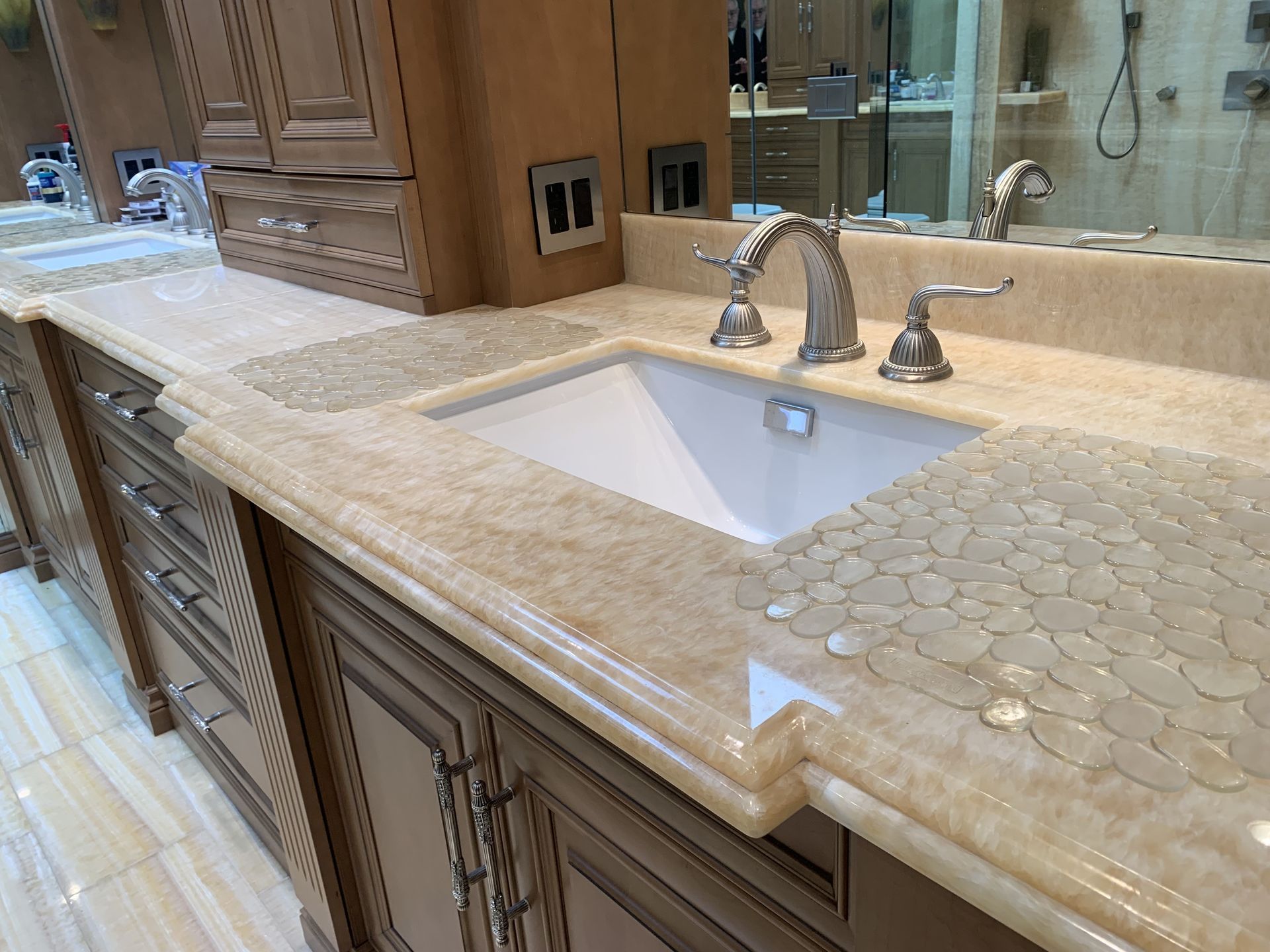A bathroom counter with a sink and a mirror