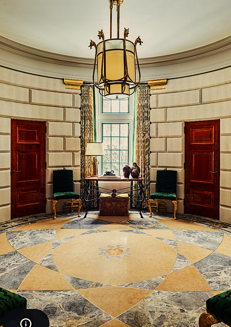 A room with a circular floor and a chandelier hanging from the ceiling
