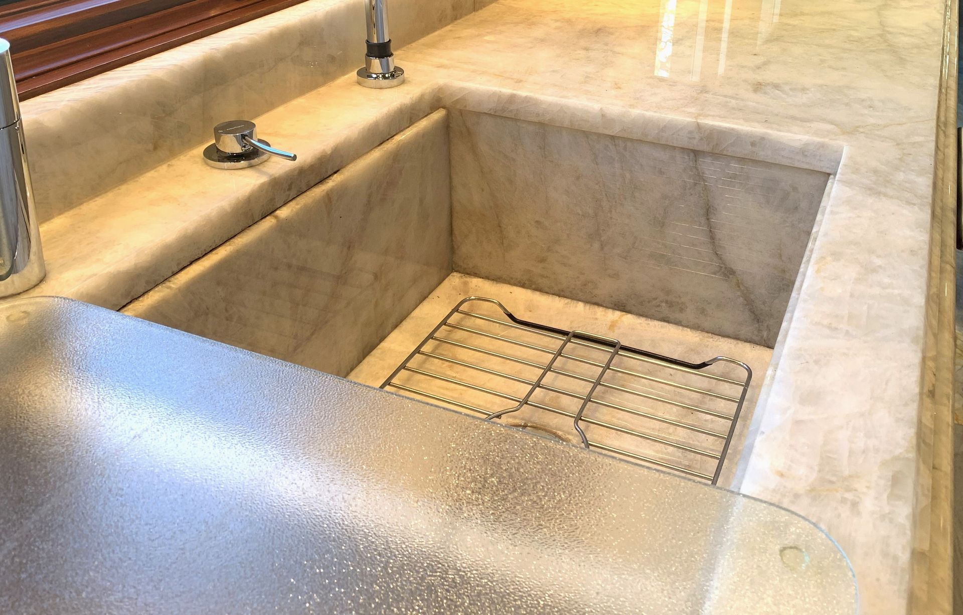 A kitchen sink with a drain board underneath it