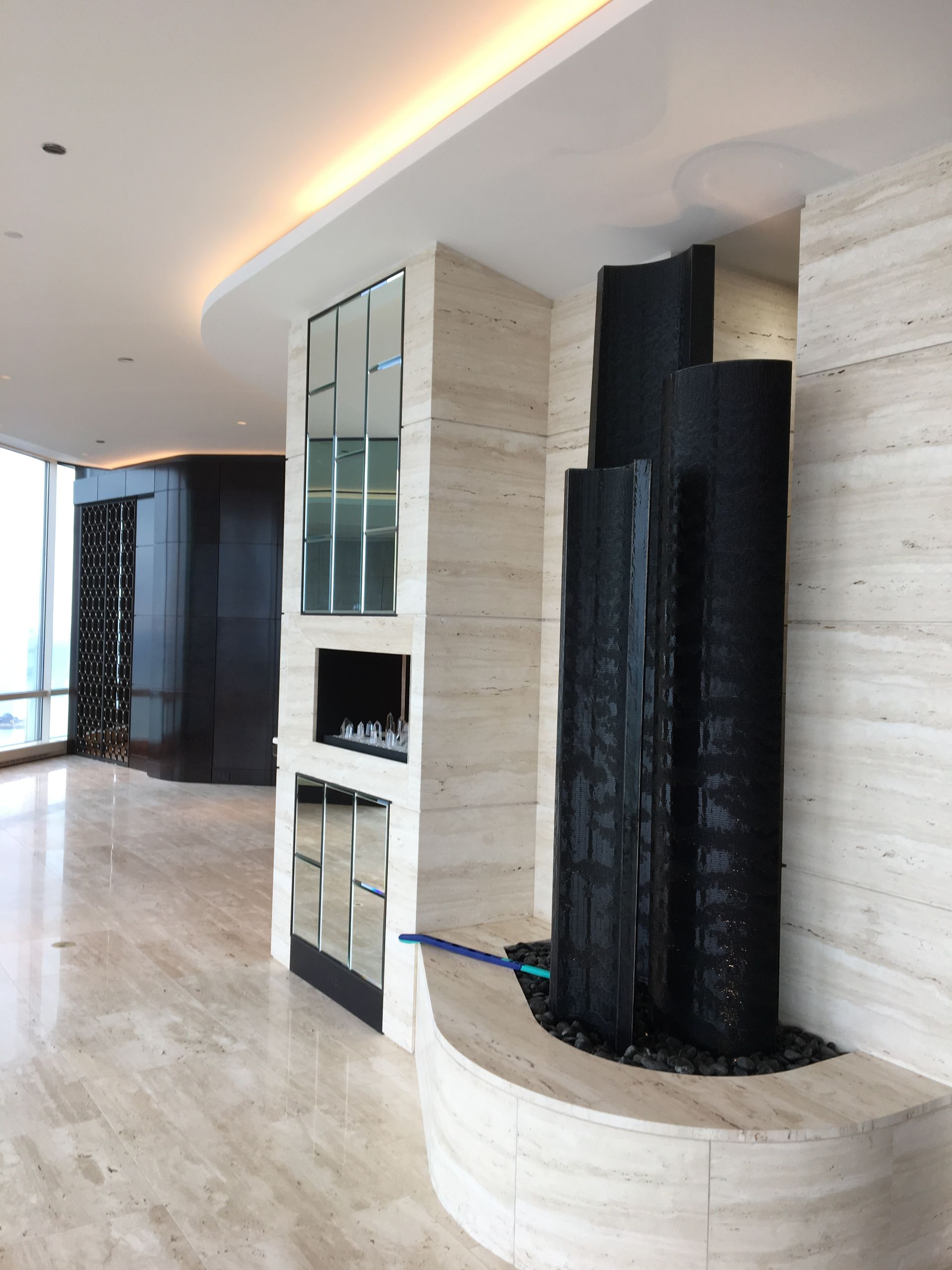 A large room with a fireplace and a fountain