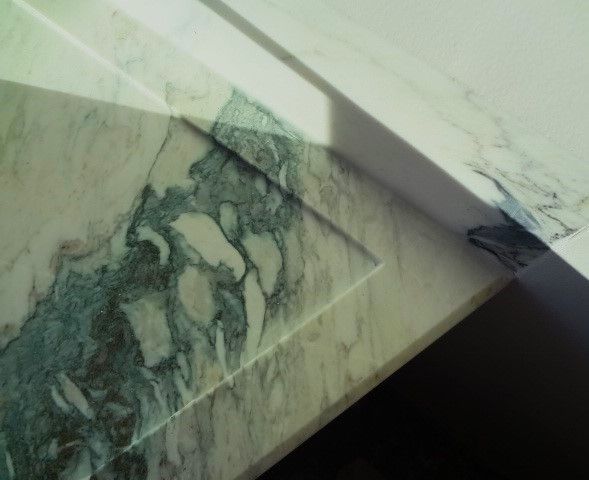 A marble counter top with a shadow on it