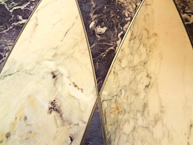 A close up of a marble floor with a geometric pattern