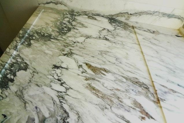 A close up of a white marble counter top
