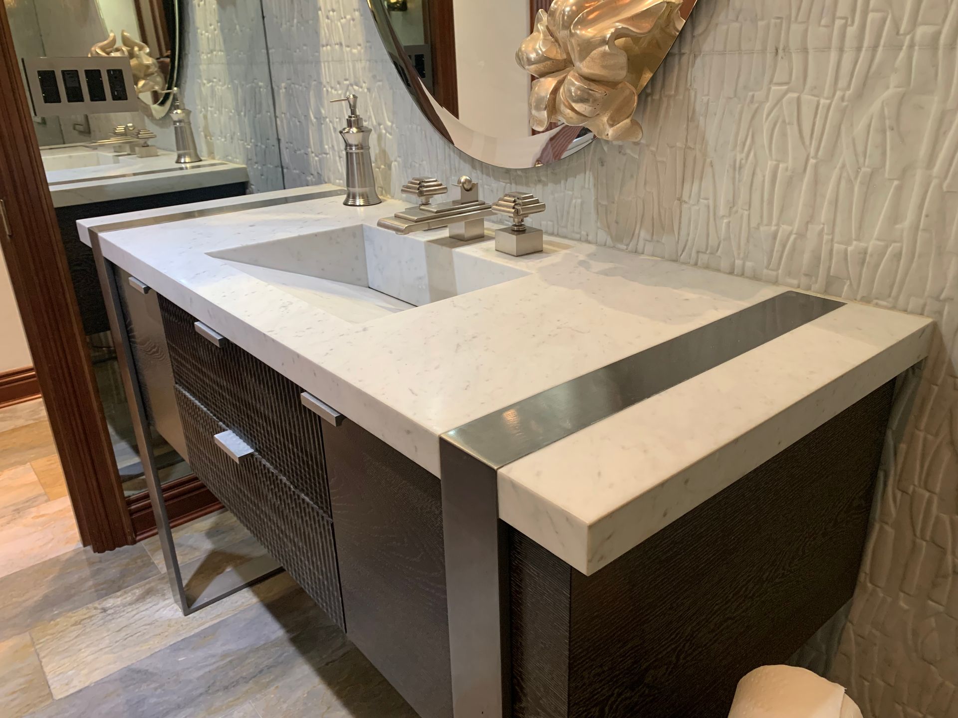 A bathroom with a sink , mirror and toilet.