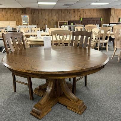 A wooden table and chairs are sitting in a room.