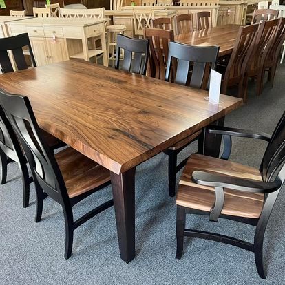 A wooden table and chairs are sitting in a room.