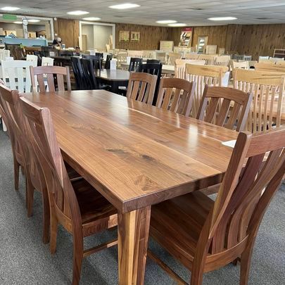 A wooden table and chairs are sitting in a room.