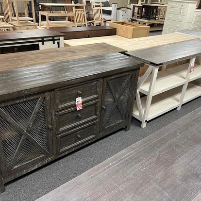 A row of wooden tables and shelves in a store.