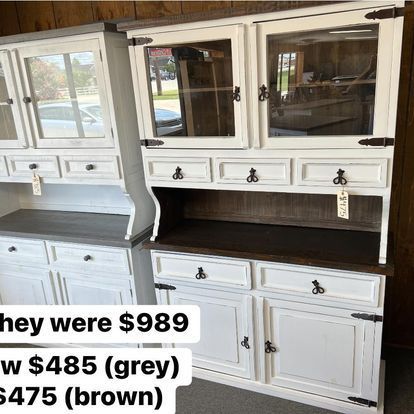 A white hutch with glass doors and drawers is for sale for $ 989